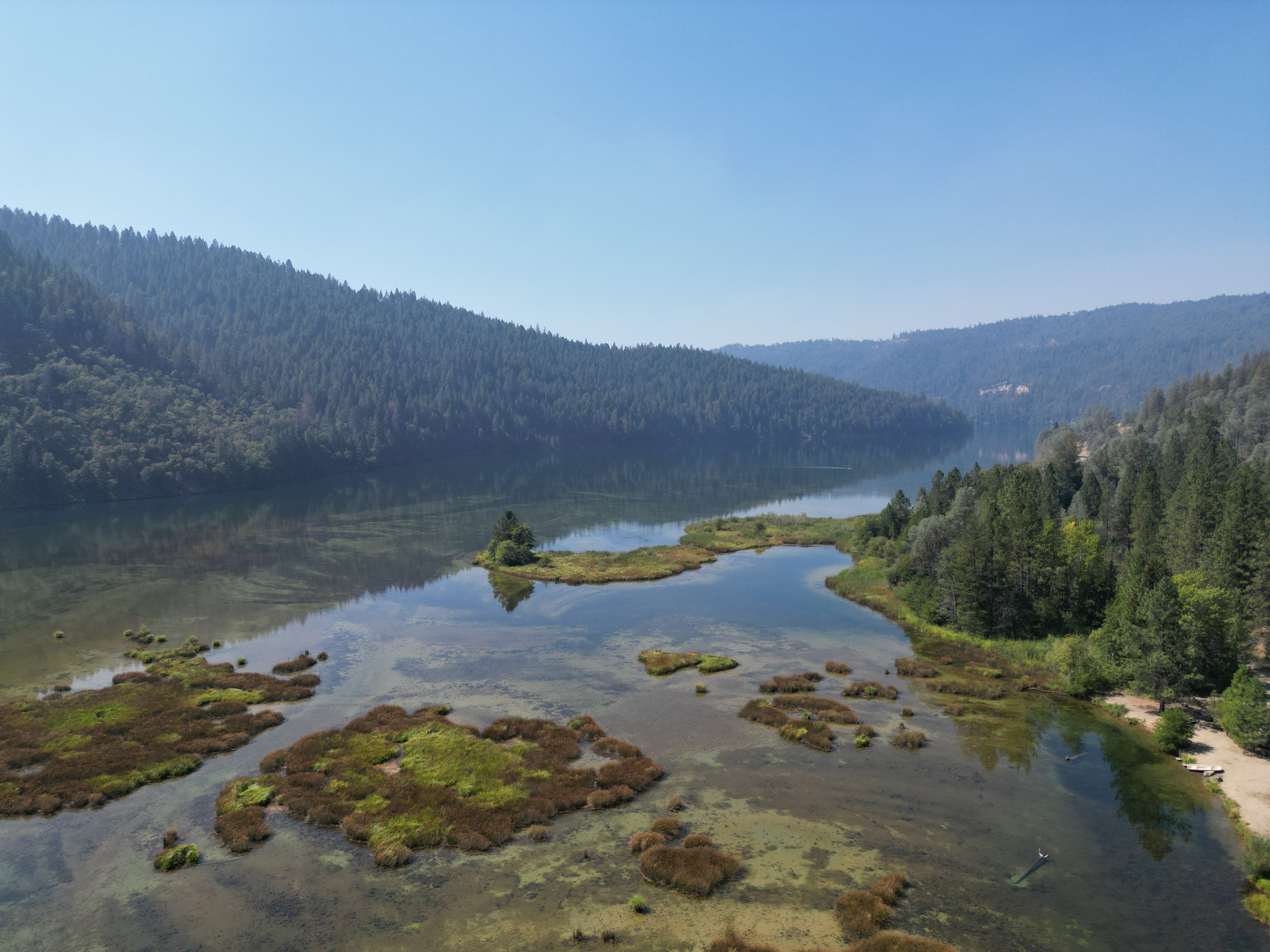 Aerial view of Lewiston Lake surrounded by pines